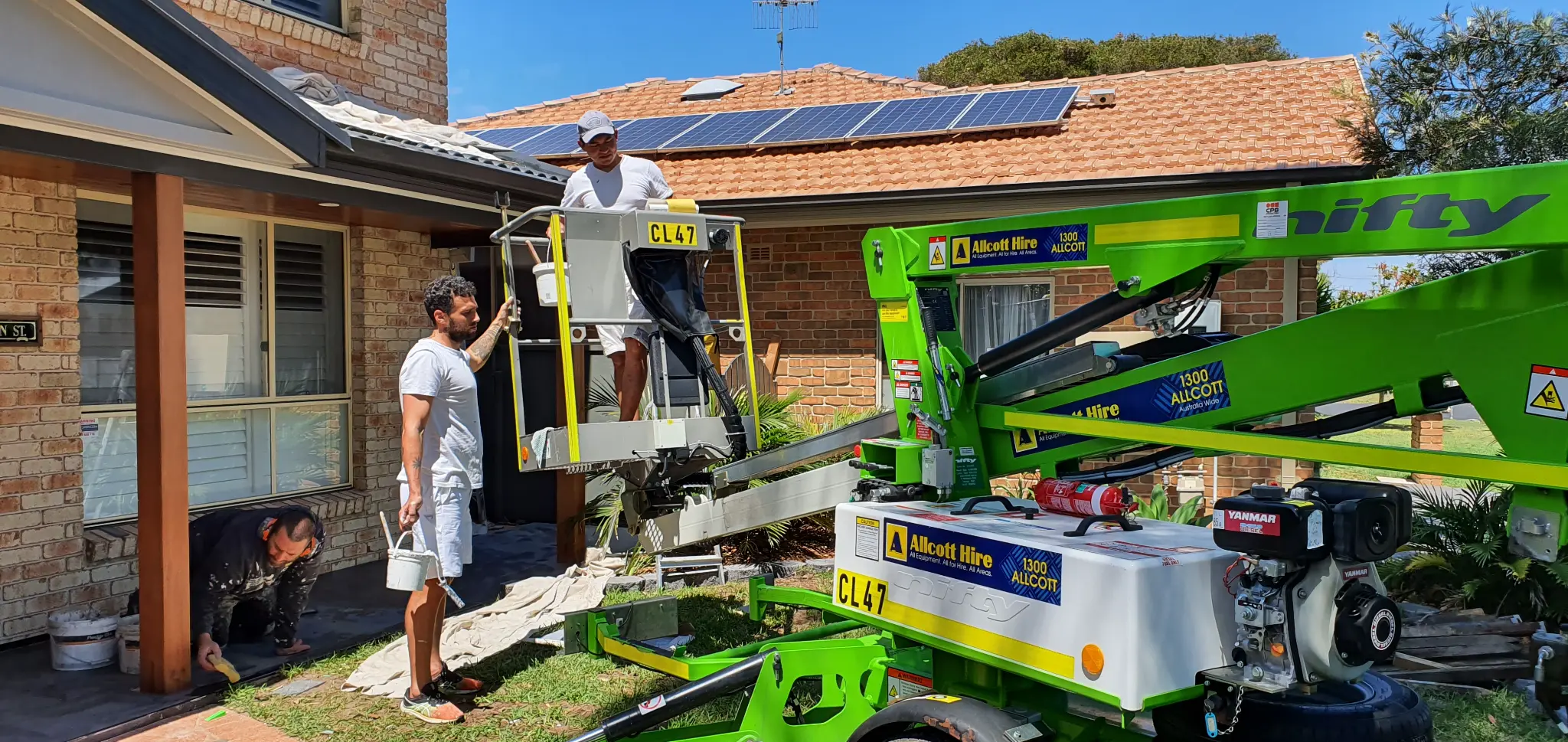 Our team using a cherry picker for high access painting